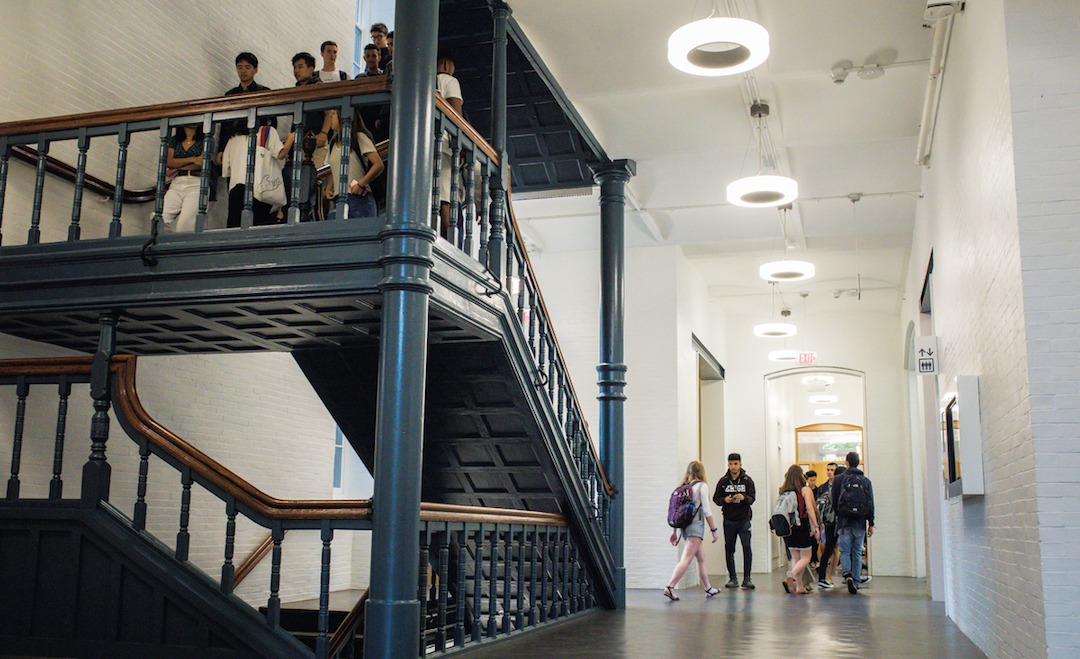 Students walking inside a campus building