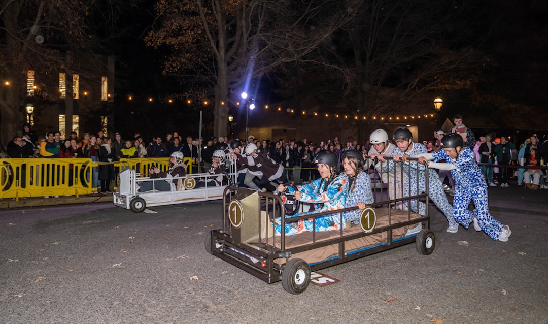 Students competing in the bed races