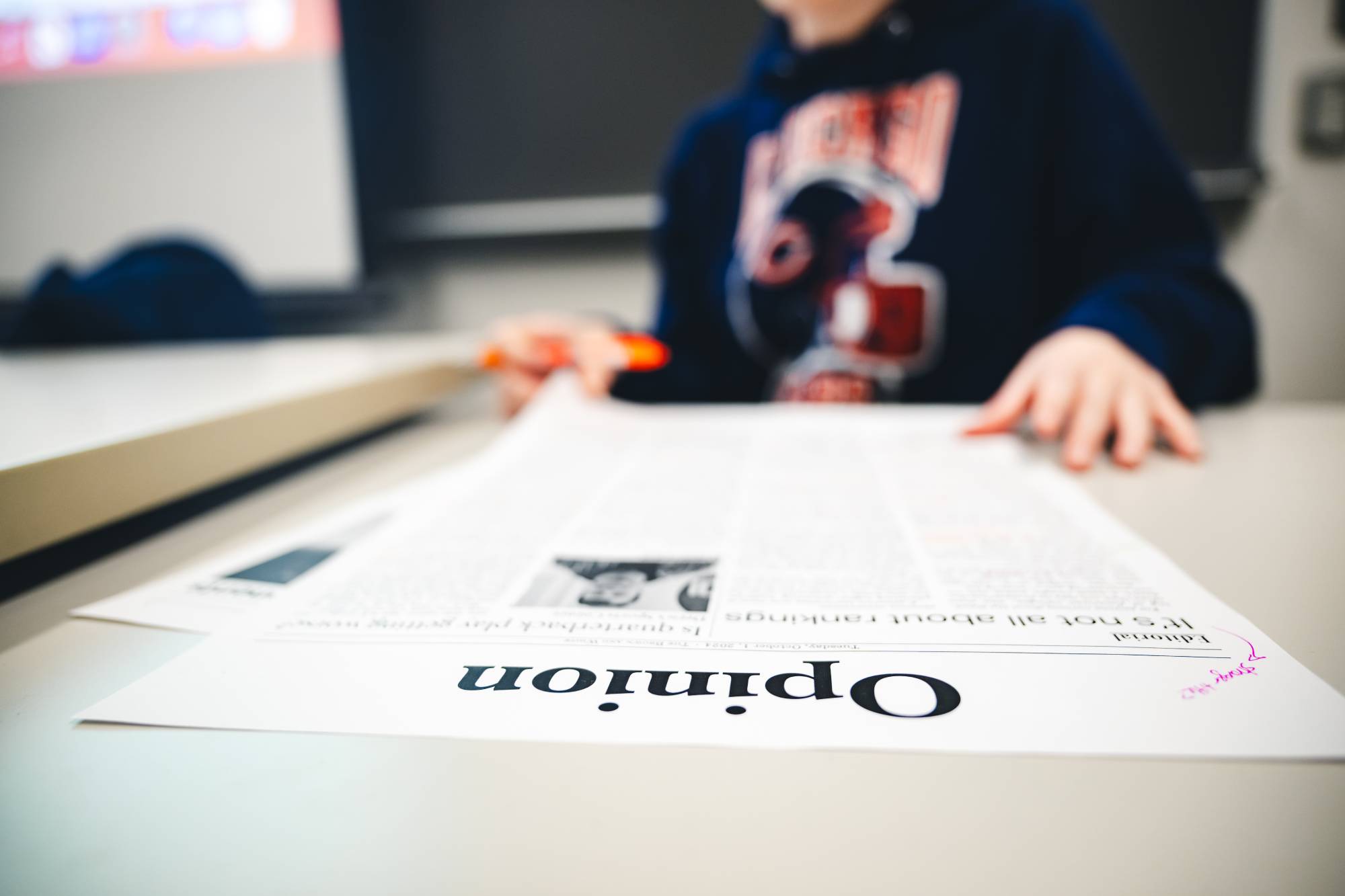 Person looking at an opinion page in a newspaper