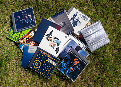 Assortment of CD cases laying in the grass
